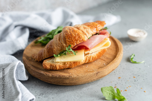 Sandwich with ham and cheese on croissant bun. Tasty croissant sandwich. Selective focus