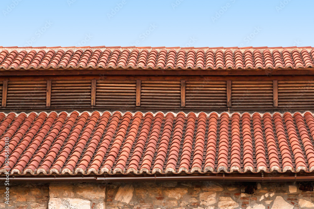 Fototapeta premium Red tile rooftop, closeup background.