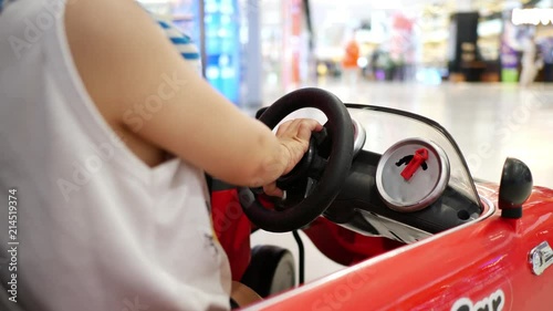 child playing small car in shopping mall department store, hand press honking horn