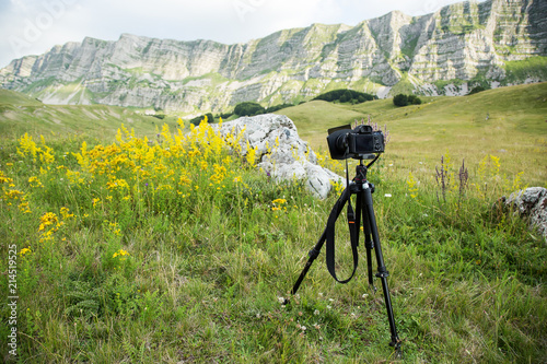 Professional dslr camera on a tripod, outdoor photography concept