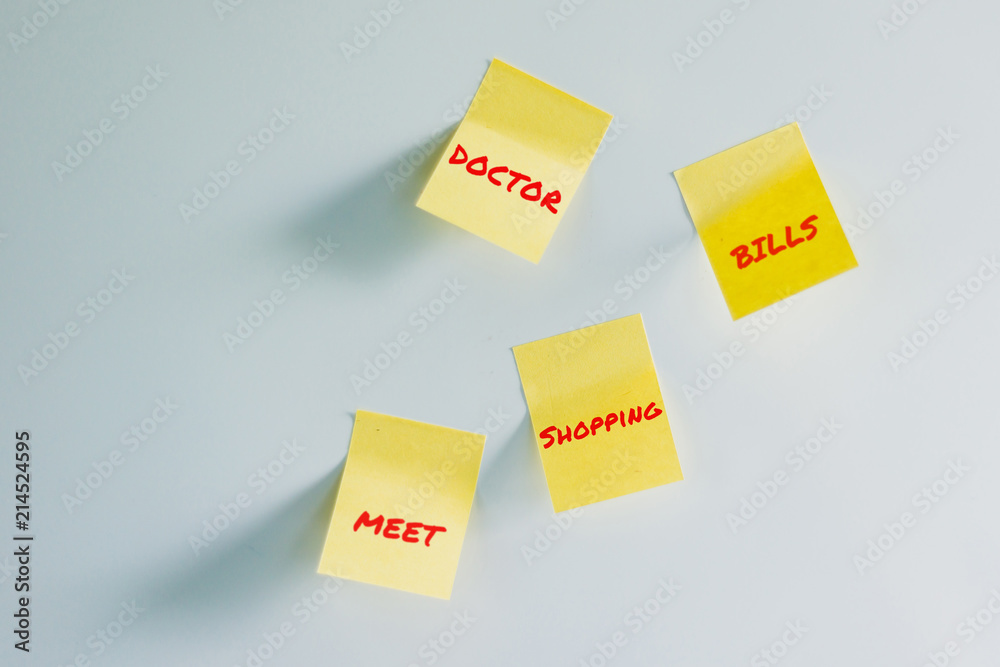 A lot of Yellow stickers to do list on a white fridge. Yellow note on fridge. Concept of reminder, alarm. Leaving a message for someone on the fridge. A lot of Yellow stickers to do list on a white fridge. Yellow note on fridge. Concept of reminder, alarm. Leaving a message for someone on the fridge.