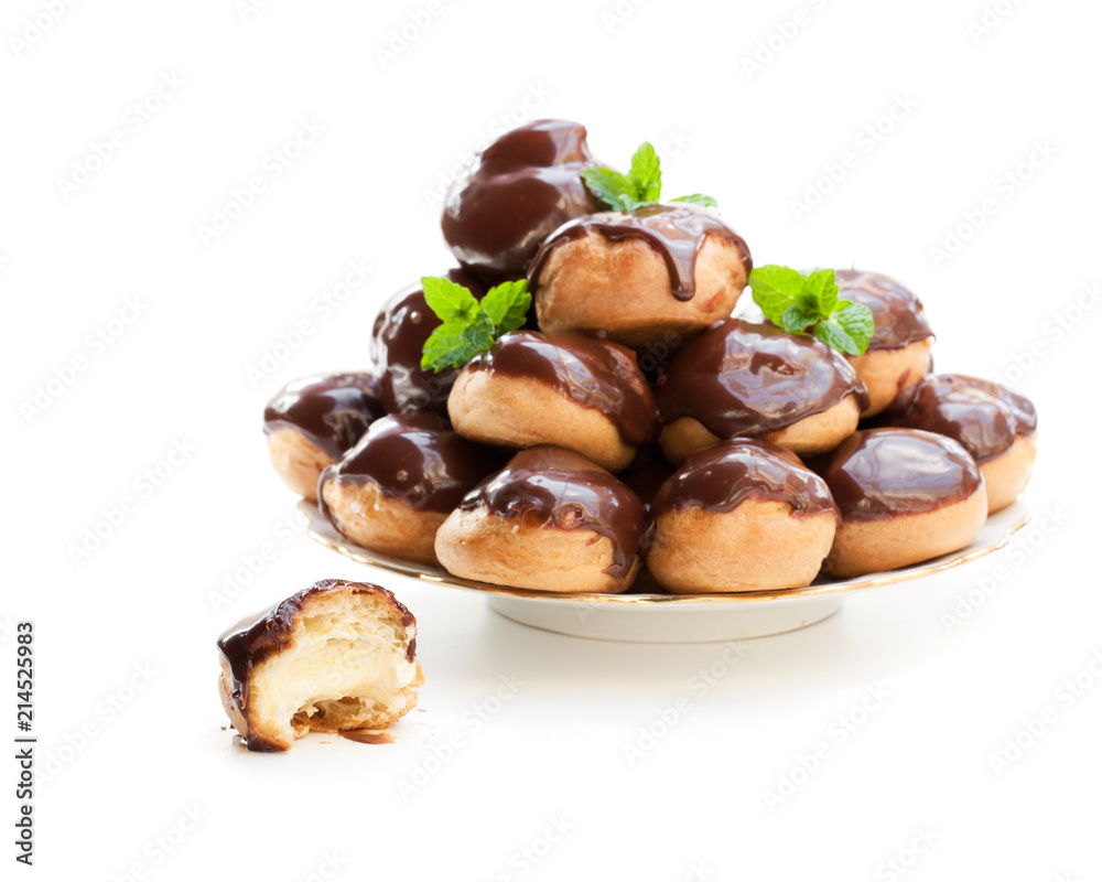 Homemade  profiterole choux with chocolate ganache on the plate isolated