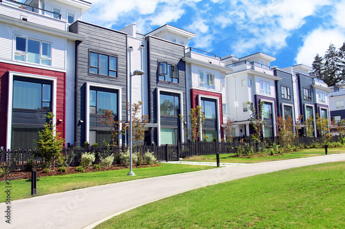 Beautiful new contempory suburban attached townhomes with colorful summer gardens in a Canadian neighborhood. photo