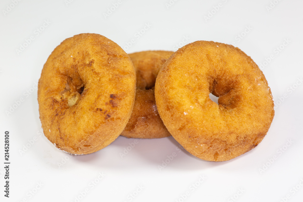 An assortment of donuts, powder donuts, chocolate donuts and plain donuts and a table waiting to be eaten An assortment of donuts, powder donuts, chocolate donuts and plain donuts and a table waiting to be eaten