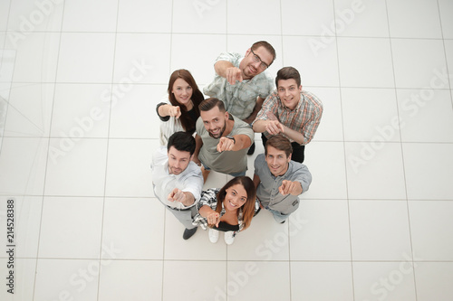 top view.a group of successful young people pointing to you © ASDF