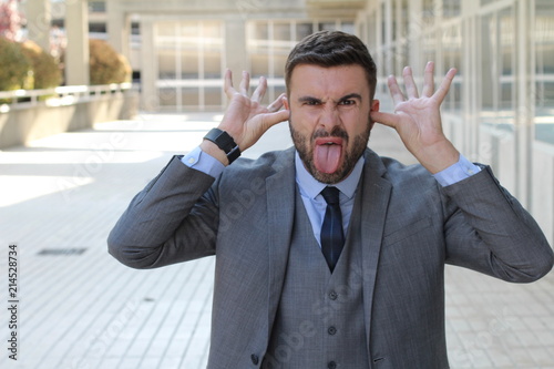 Childish businessman doing an obscene gesture