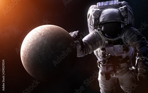 Fototapeta Naklejka Na Ścianę i Meble -  Mercury on a blurred background with a giant astronaut. Elements of the image are furnished by NASA