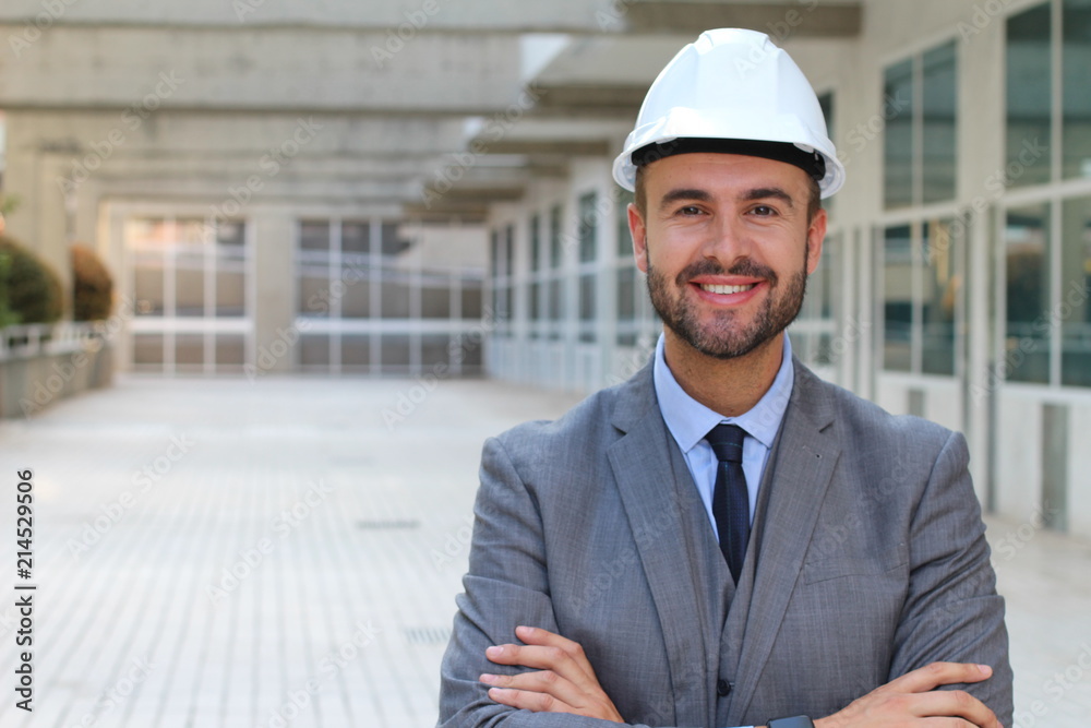 Engineer with white helmet smiling in office space Engineer with white helmet smiling in office space
