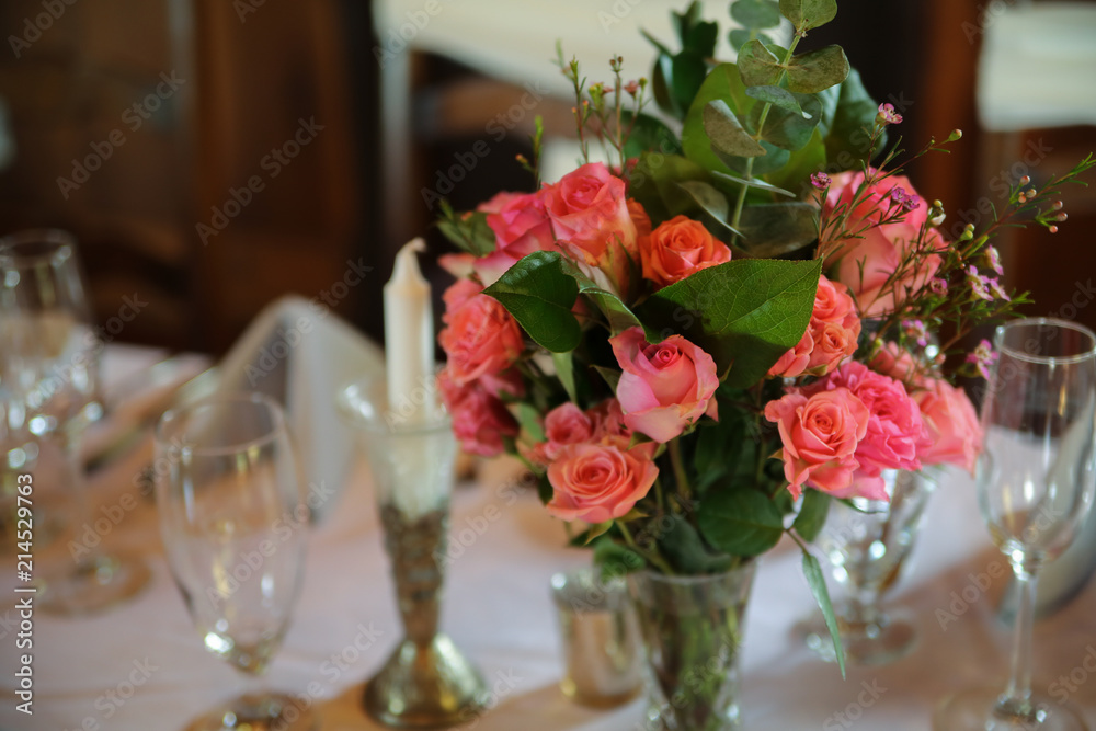 Wedding Reception Table Decorated with Silver and a Pink, White, and Green Centerpiece of Roses