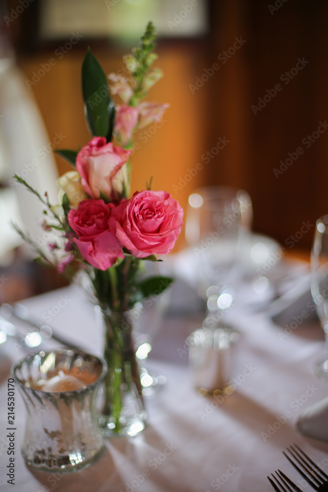 Wedding Reception Table Decorated with Silver and a Pink, White, and Green Centerpiece of Roses Wedding Reception Table Decorated with Silver and a Pink, White, and Green Centerpiece of Roses