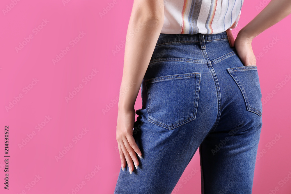 Woman in stylish blue jeans on color background Woman in stylish blue jeans on color background