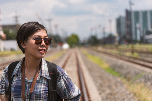 outdoor summer travel with train transportation of pretty young woman backpack for travel and journey,hipster outfit casual style and travel accessories with glasses, vintage tone © srijaroen