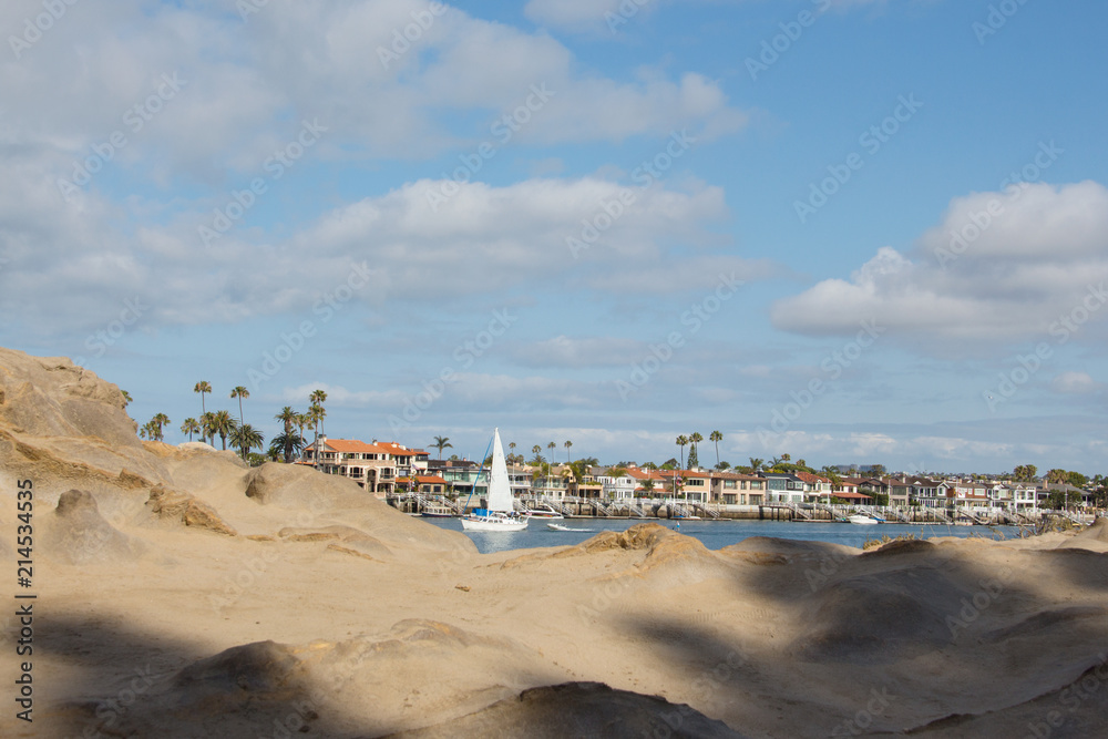 Southern California coastline.  View of the coastal access to the harbor from a rocky cliff.  Cityscape of the marina.