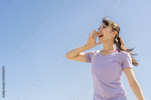 portrait of sporty asian woman blue sky