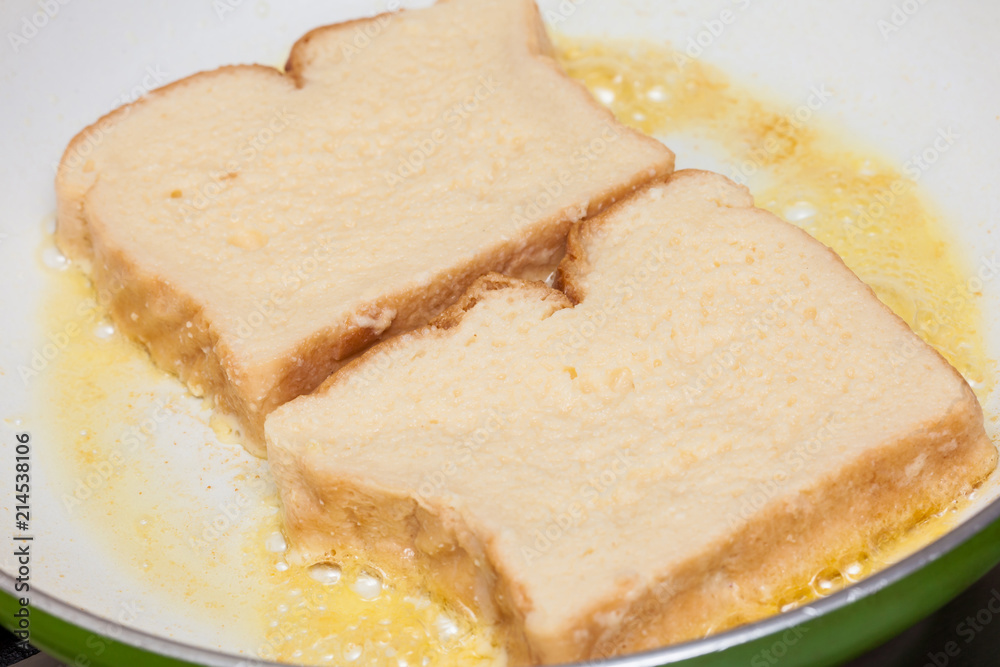 French toast preparation: Cooking french toasts on a pan