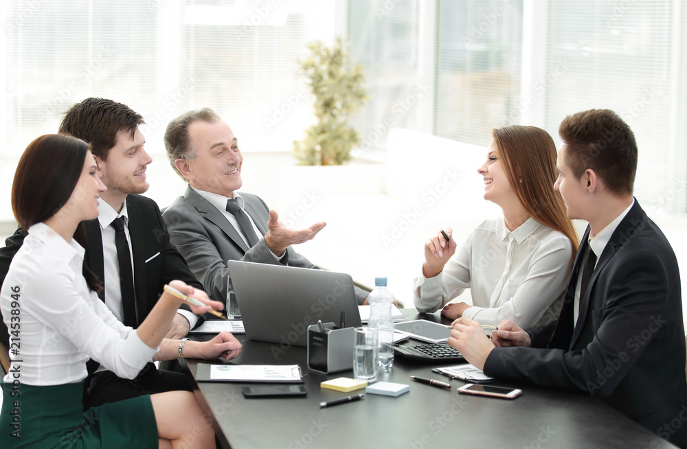 business colleagues talking at Desk in the office business colleagues talking at Desk in the office
