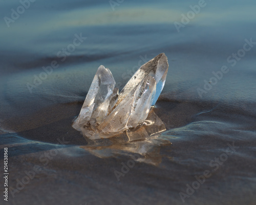 Himalayan Clear Quartz Laser Cluster on wet sand near the water on the beach at sunrise.