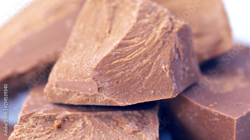 Chunks of chopped premium Belgian Gianduja chocolate macro closeup. photo