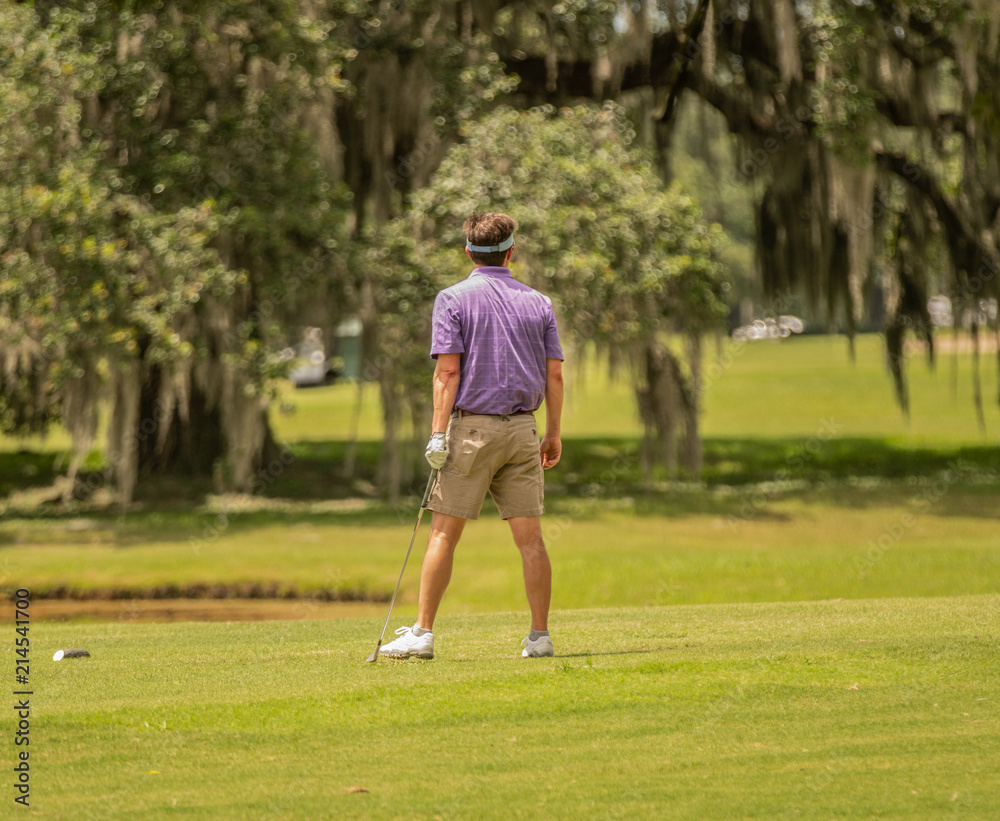 unknown golfer is unsure of his shot
