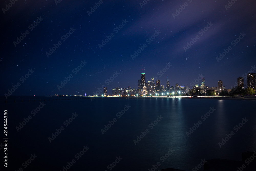 A evening skyline view of Chicago with star trails and moving clouds