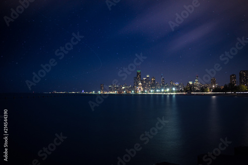 A evening skyline view of Chicago with star trails and moving clouds