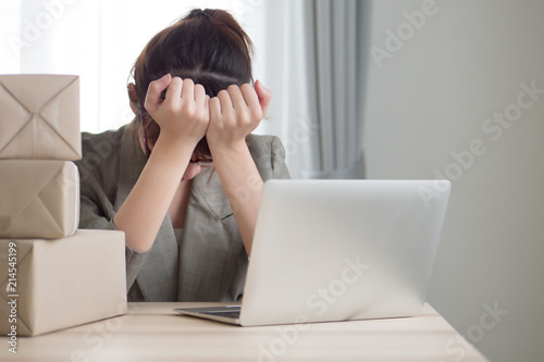 asian woman business owner working with stress and headache; portrait of sad stress unhappy business woman getting headache from business failure, loss, problem; adult asian chinese woman model