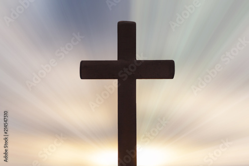Silhouettes of crucifix and colourful sky background