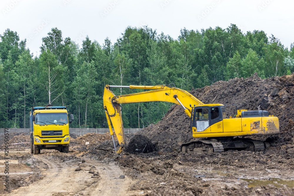 Excavator load the earth into a dump truck Excavator load the earth into a dump truck