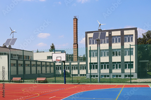 Lubno, Poland - july 9 2018:An open stadium in the courtyard of a village school. Eduction of the younger generation. Sports ground for football, volleyball and basketball. Lighting on natural sources photo