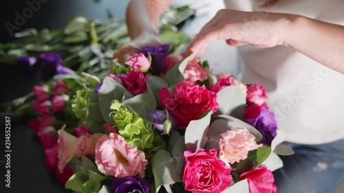 Florist girl makes a floral box in a flower salon, close-up photo