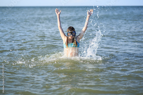 girl of thirteen in a mask for diving into the sea