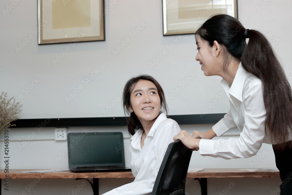 Cheerful young Asian business woman playing together with chair in office. Cheerful young Asian business woman playing together with chair in office.