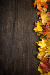 autumn leaf on wood background (top view) orange leaf on old grunge wood deck, copy place for inscription, tablet for text