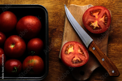 tomatoes and knife on cutting board background