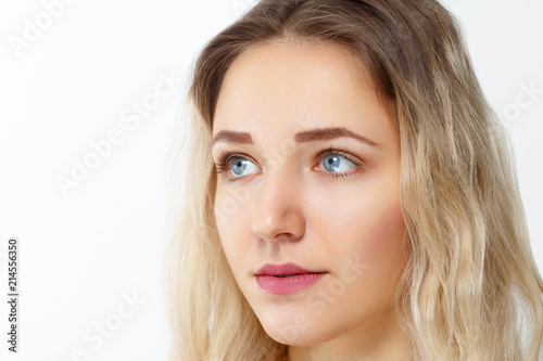 Pretty young girl with make-up poses in studio, close up portrait