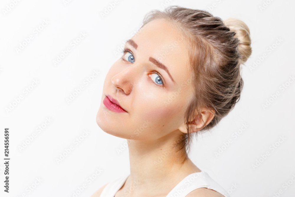 Beautiful young girl with make-up and blue eyes poses in studio, close up portrait Beautiful young girl with make-up and blue eyes poses in studio, close up portrait
