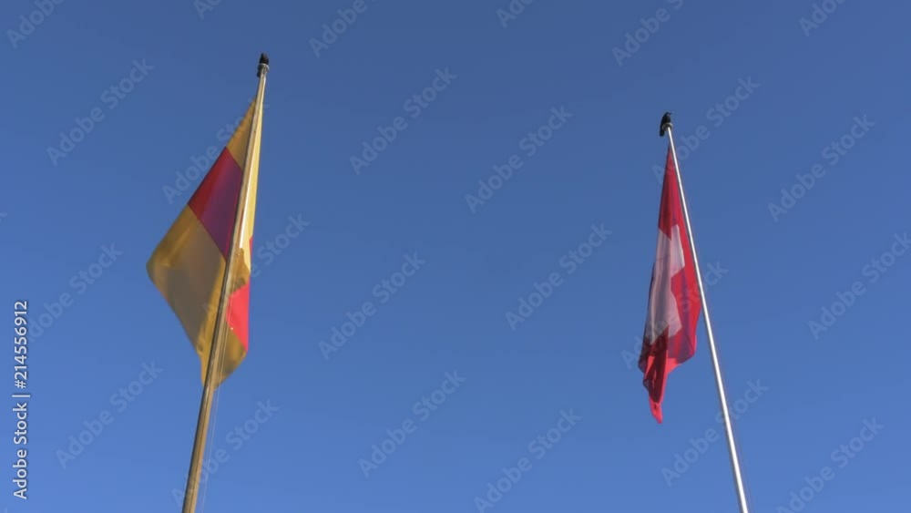 Swiss Flags Behind an Immaculate Blue Sky Swiss Flags Behind an Immaculate Blue Sky