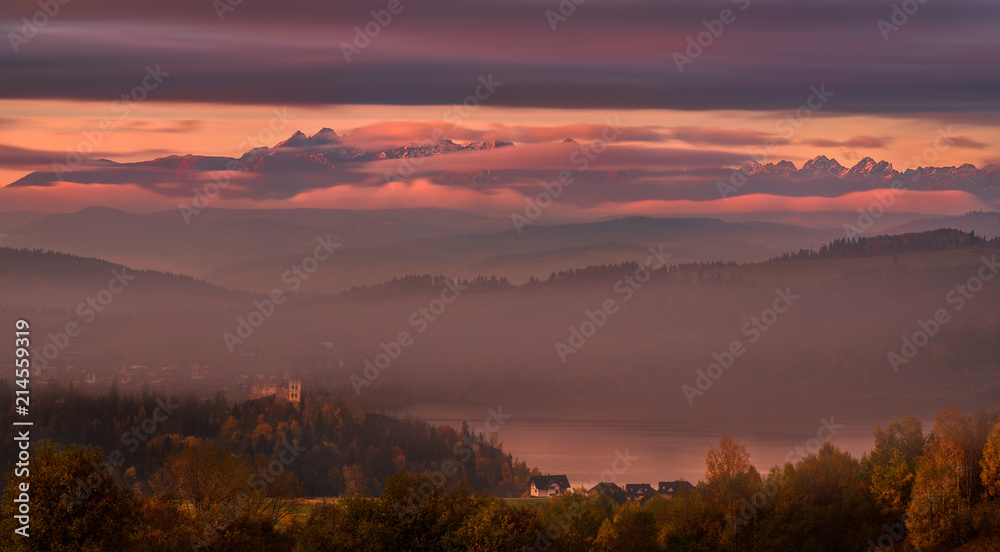 Pinky Autumn Foggy Morning In High Tatras, Poland.View Of The Mountains, The Czorsztyn Lake And The Castle With The Same Name. Landscape Of Polish Tatra Mountains In The Clouds.Epic Sunrise Over Tatry