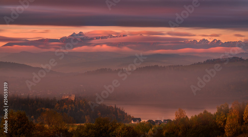 Pinky Autumn Foggy Morning In High Tatras, Poland.View Of The Mountains, The Czorsztyn Lake And The Castle With The Same Name. Landscape Of Polish Tatra Mountains In The Clouds.Epic Sunrise Over Tatry