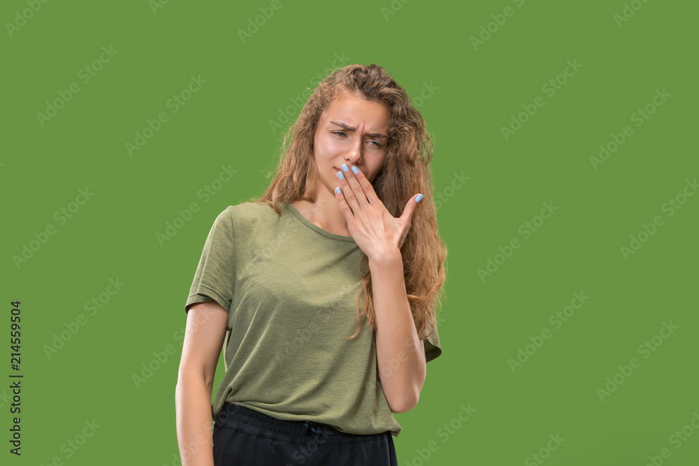 Let me think. Doubtful pensive woman with thoughtful expression making choice against green background Let me think. Doubtful pensive woman with thoughtful expression making choice against green background