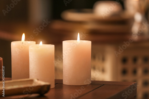 Burning candles on table in spa salon