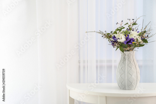 Vase with beautiful bouquet of different flowers as gift on table