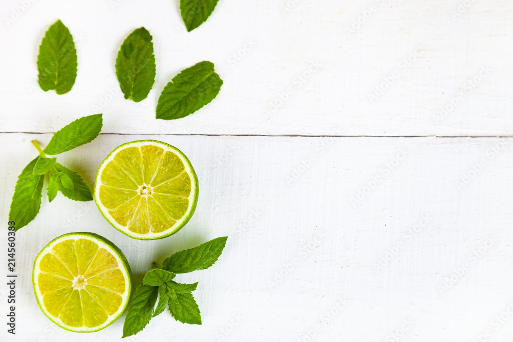 Lime and mint on a wooden table. Lime and mint on a wooden table.