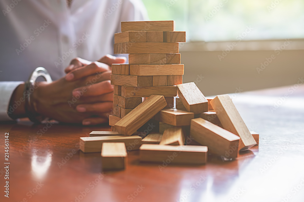 Problem Solving Business can't stop effect of dominoes continuous toppled with business team feeling sad and stress in office background. Failure Business Concept. Problem Solving Business can't stop effect of dominoes continuous toppled with business team feeling sad and stress in office background. Failure Business Concept.