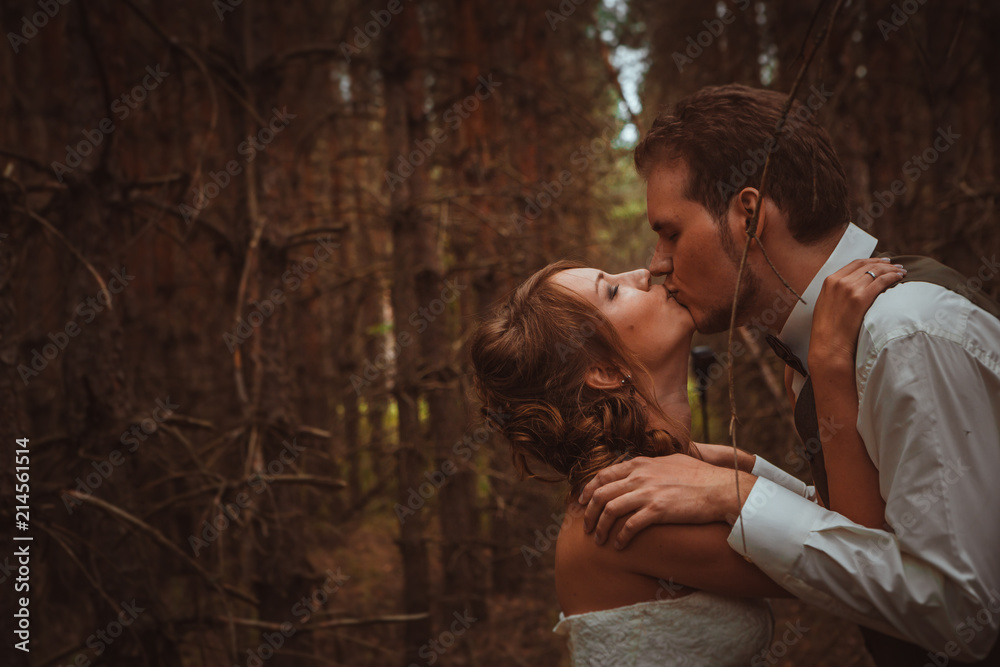 bride and groom in the forest of firs