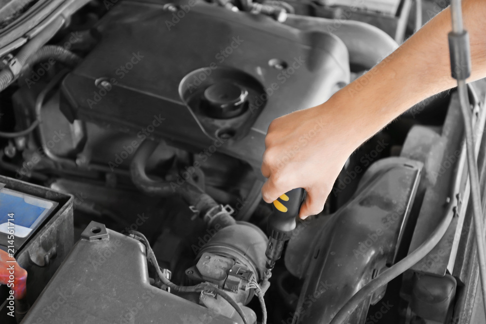 Male mechanic fixing car in service center Male mechanic fixing car in service center