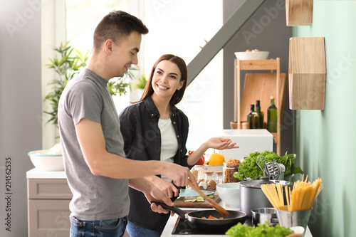 Young couple cooking health...