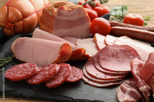 Assortment of delicious deli meats on slate plate