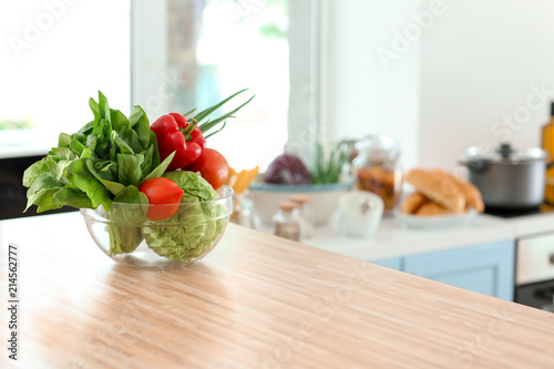 Bowl with fresh vegetables on table in kitchen