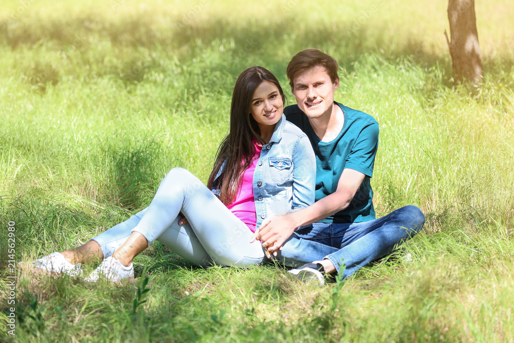 Happy young couple resting in green park Happy young couple resting in green park